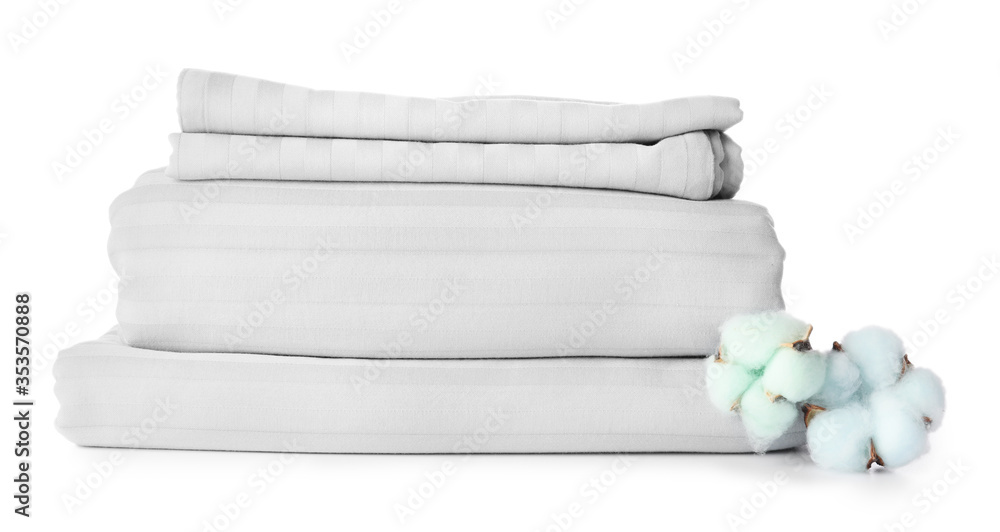 Stack of clean bed sheets on white background