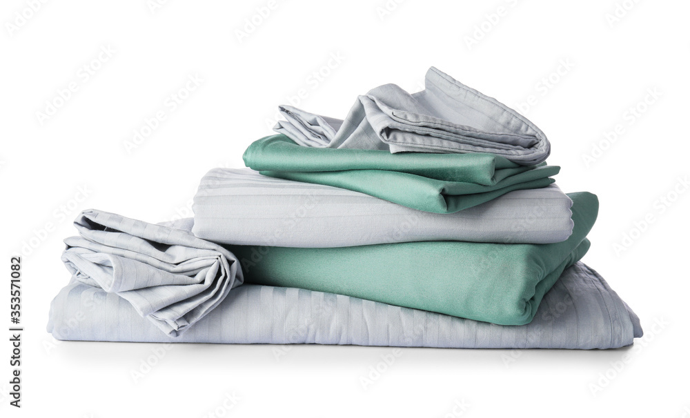 Stack of clean bed sheets on white background