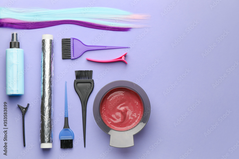 Supplies for hair coloring on color background