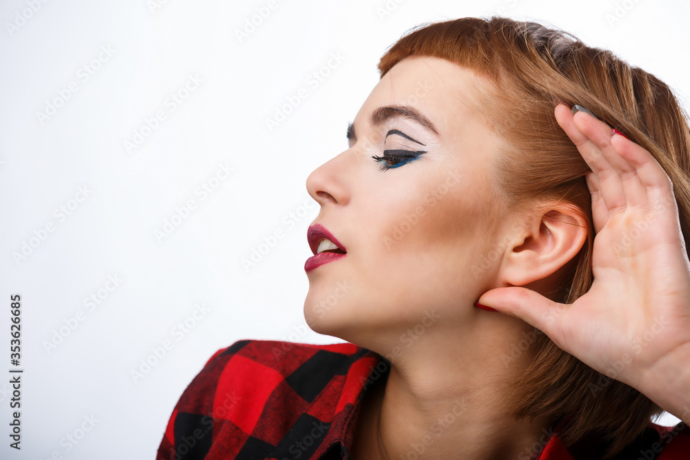 Portrait with different happy emotions. Lady holds hand near ear. Listen carefully.