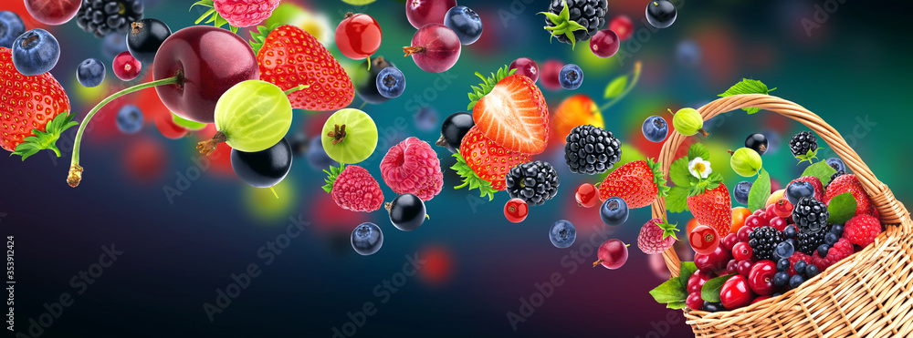 Fresh berries in wicker basket isolated on multicolor background