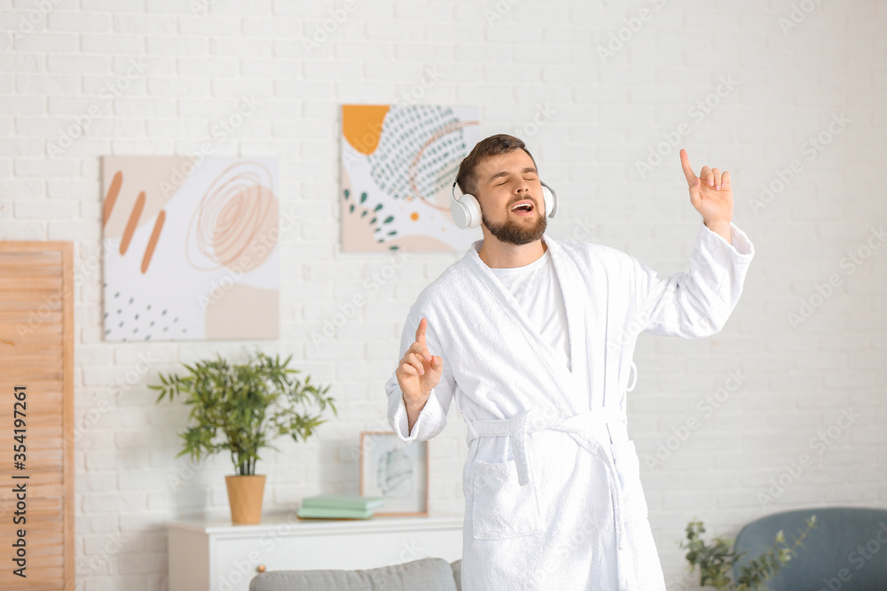 Handsome young man dancing at home