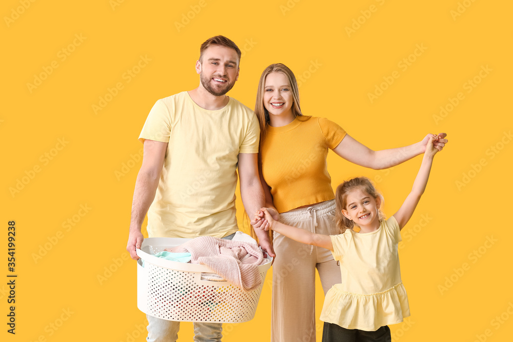 Family with laundry on color background