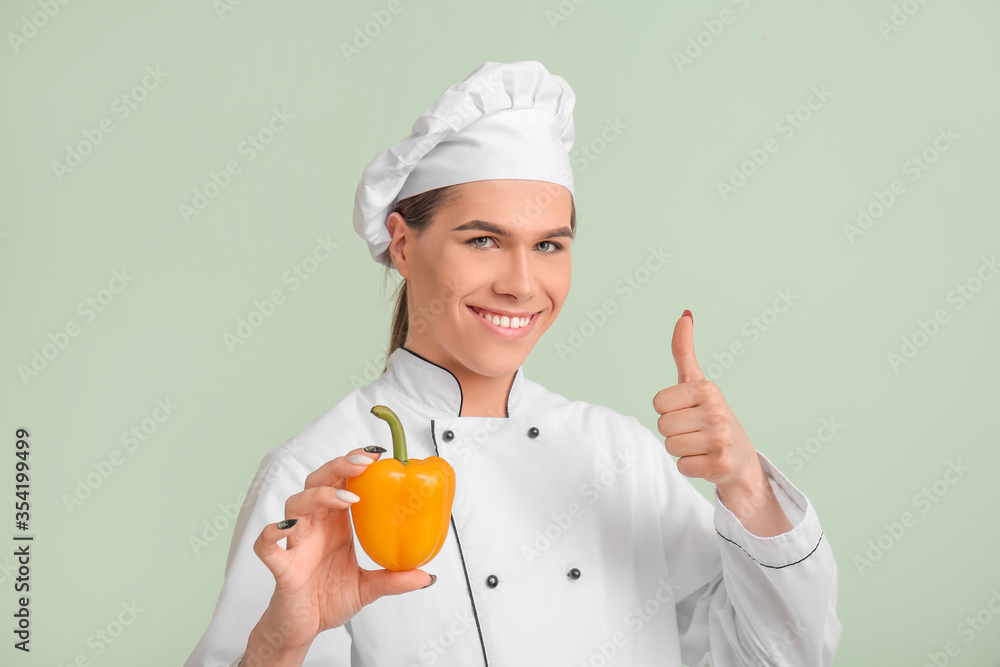 Transgender chef showing thumb-up on color background