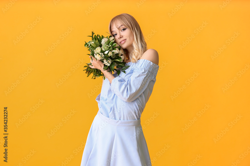 Beautiful young woman with bouquet of roses on color background