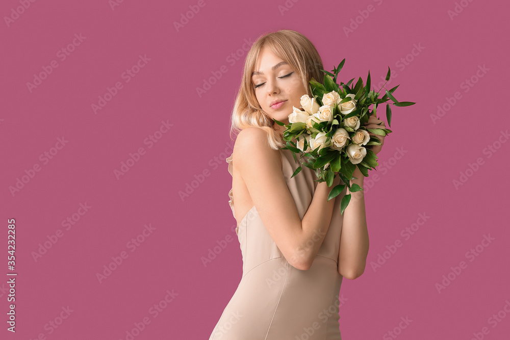 Beautiful young woman with bouquet of roses on color background