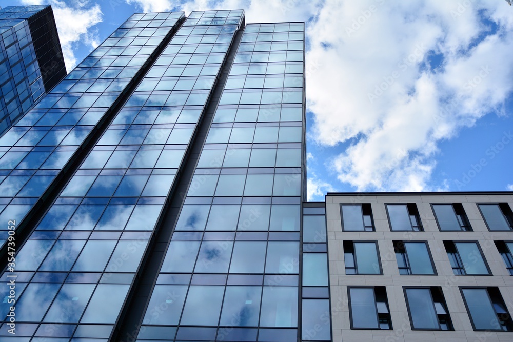 Facade texture of a glass mirrored office building. Fragment of the facade. Modern architecture of t