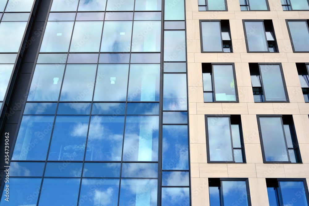 Facade texture of a glass mirrored office building. Fragment of the facade. Modern architecture of t