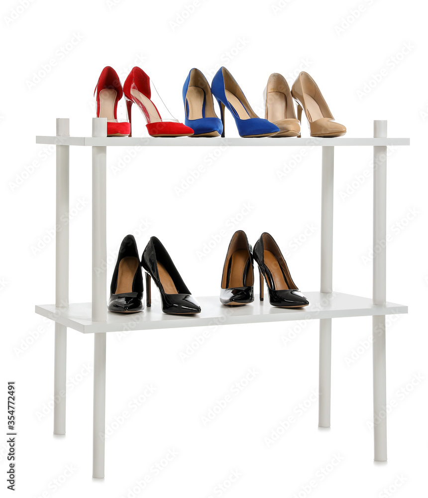 Stand with stylish shoes on white background