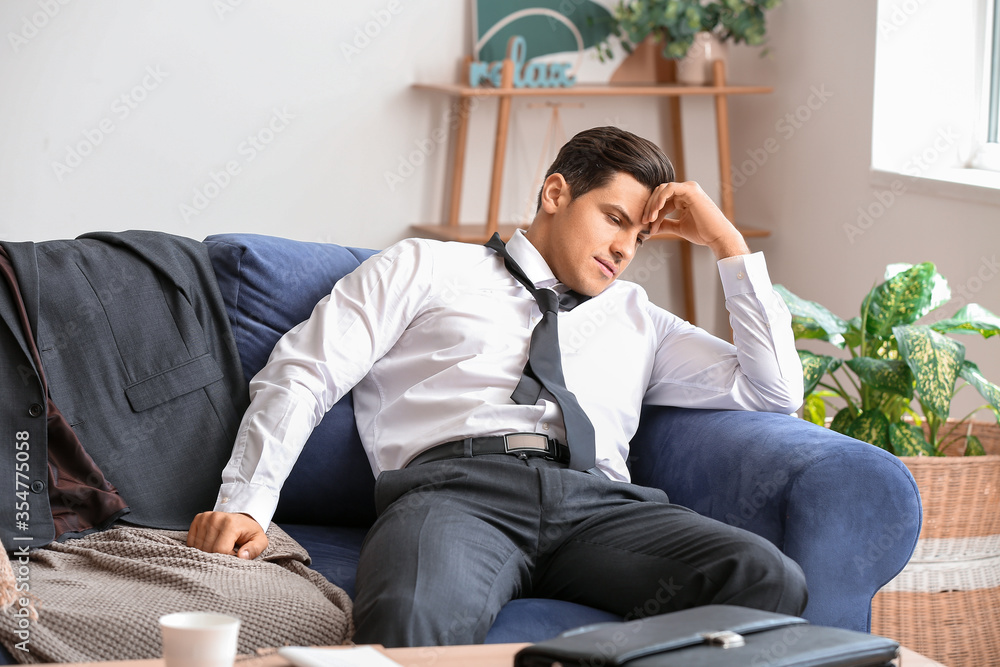 Young businessman resting at home after long working day