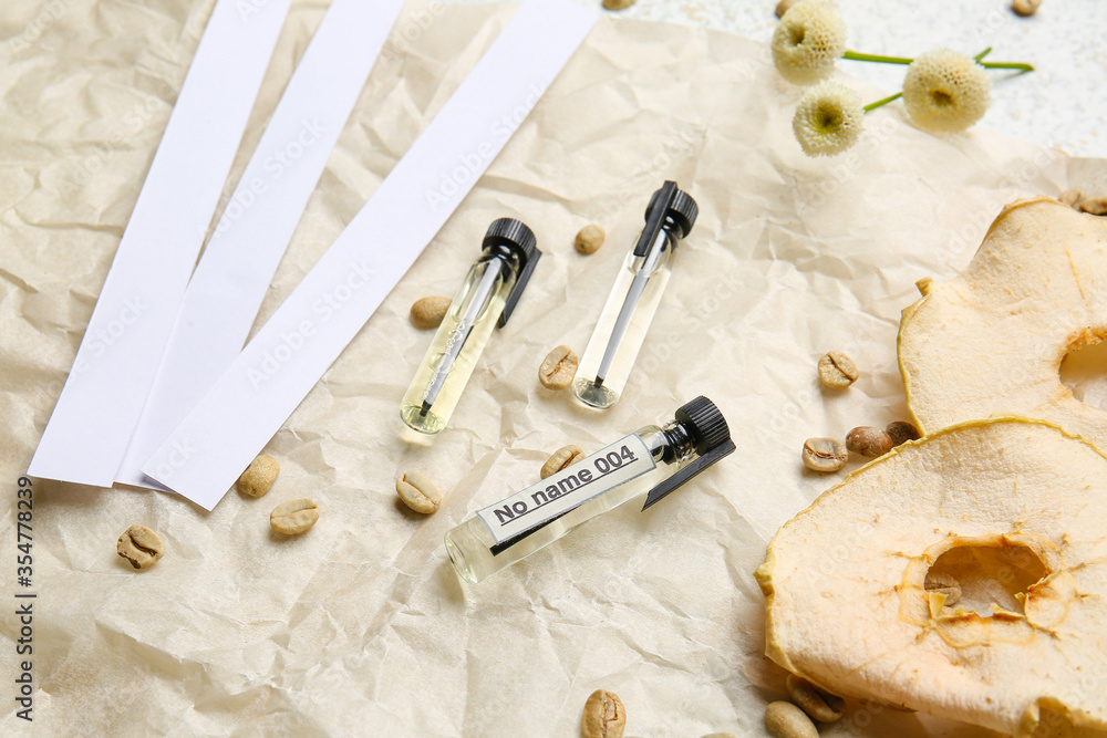 Perfume samples with ingredients on parchment