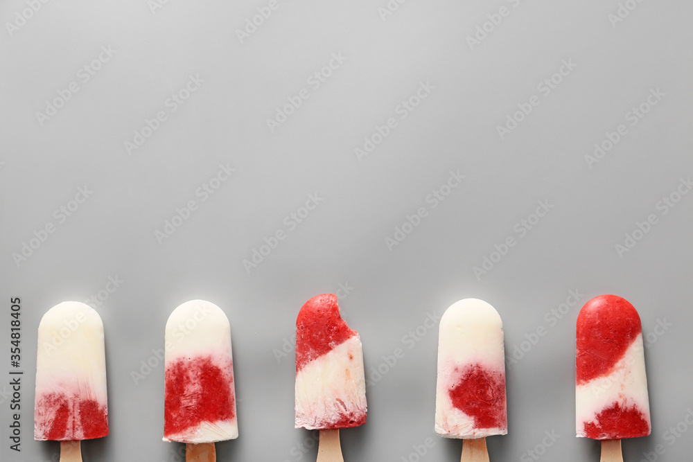 Tasty strawberry ice cream on grey background