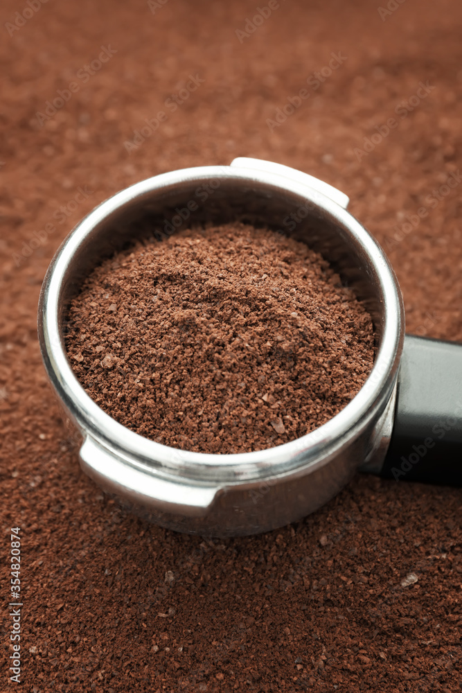 Metal scoop on coffee powder, closeup