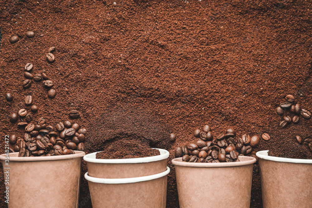 Paper cups and coffee beans on powder