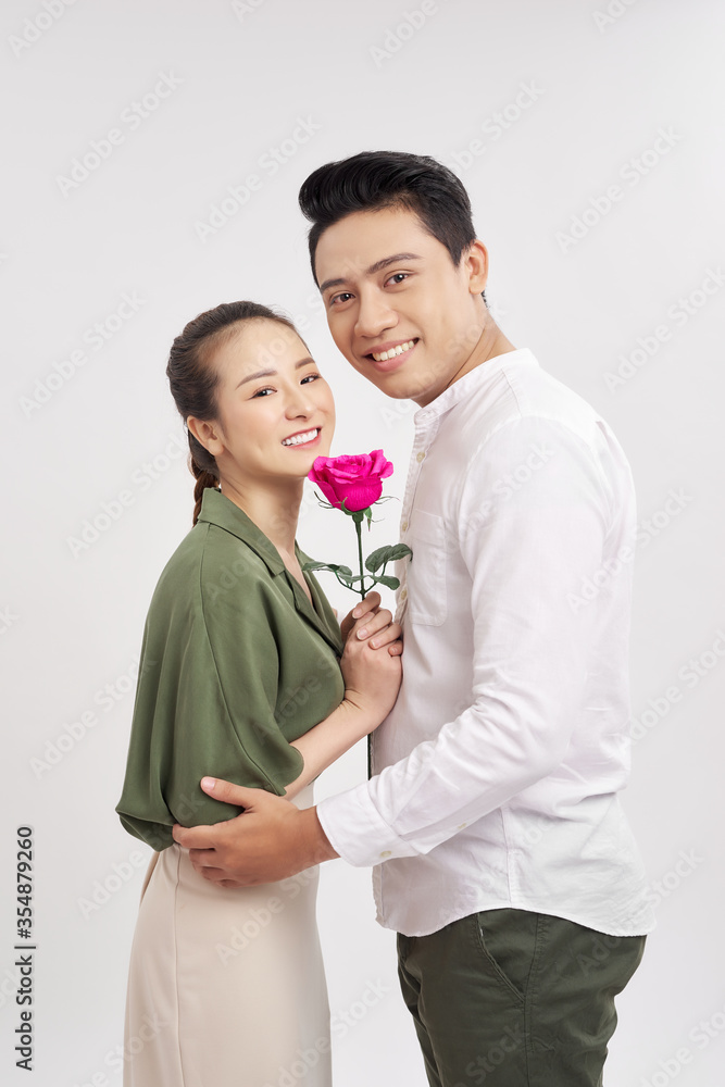 Man offering a rose to his girlfriend over white