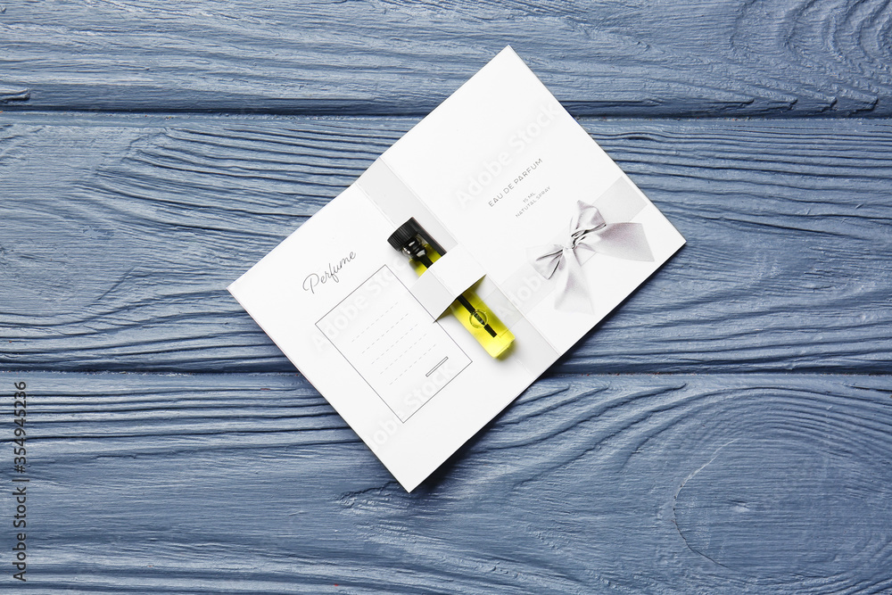 Perfume sample on wooden background