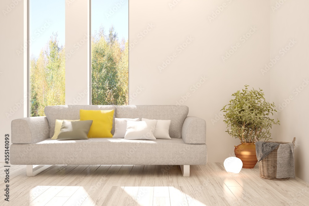 White stylish minimalist room with sofa and autumn landscape in window. Scandinavian interior design