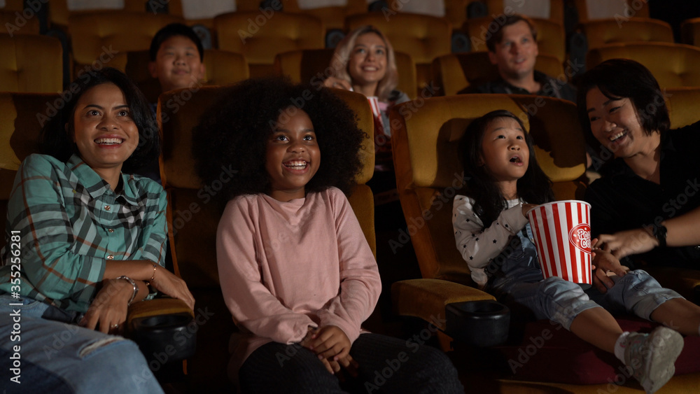 People audience watching movie in the movie theater cinema. Group recreation activity and entertainm