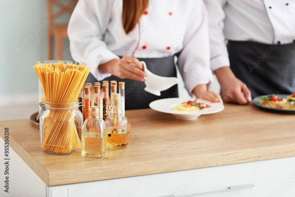 Male and female chefs cooking in kitchen