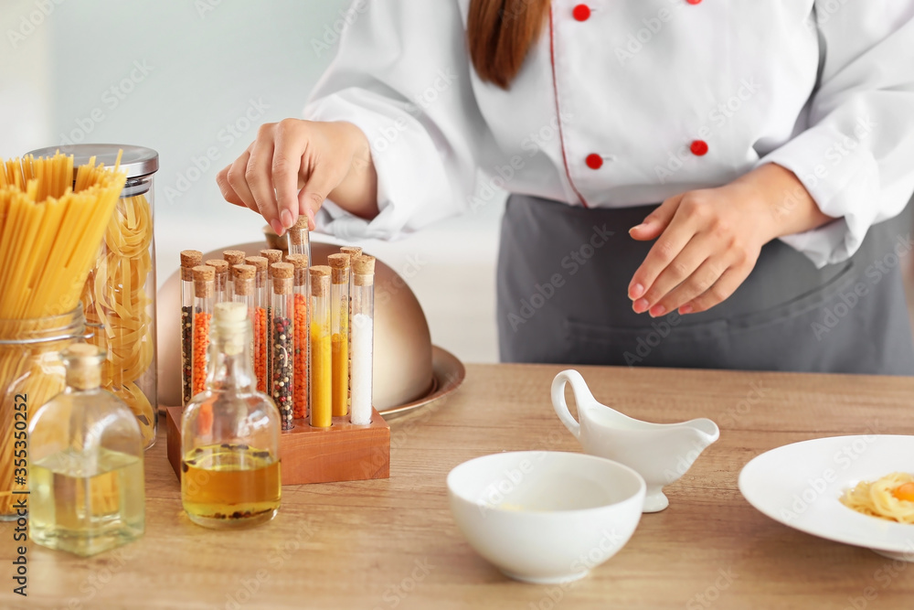 Female chef cooking in kitchen, closeup