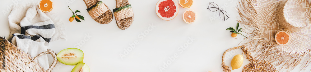 Summer mood layout. Flat-lay of natural espadrillas and sandals, straw sunhat, beach rafia and net b