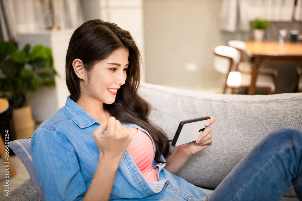 asian woman play mobile games