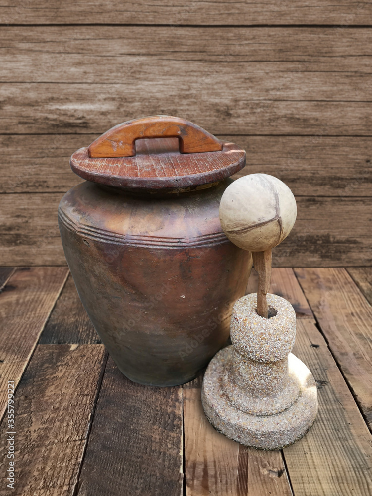 Clay blister with wooden bowl, scoop water, wooden background in soft focus and clipping path.