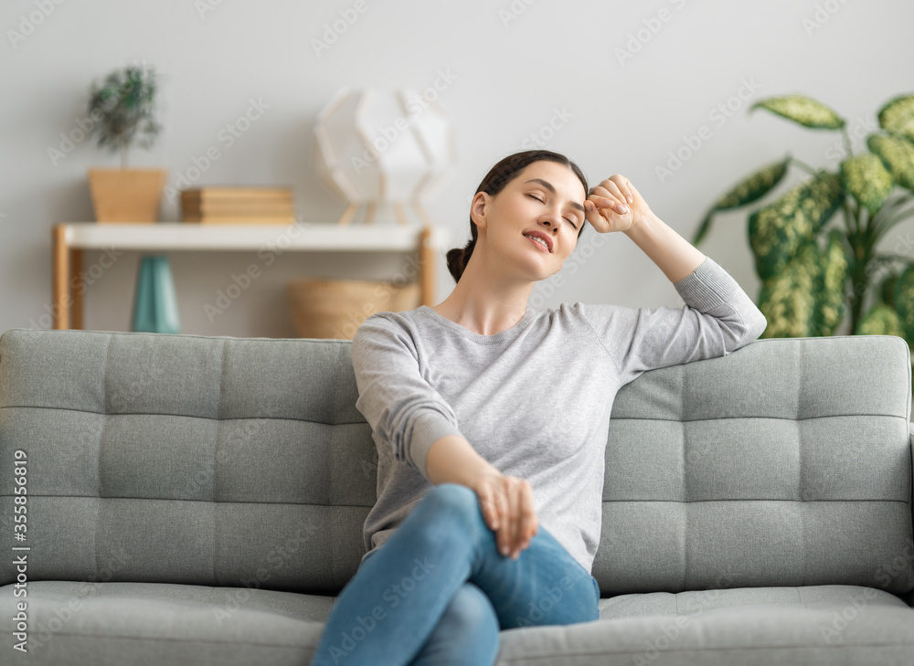 woman resting on sofa at home