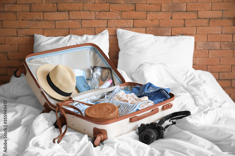 Open packed suitcase on bed