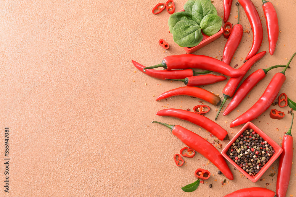 Composition with hot chili pepper on color background