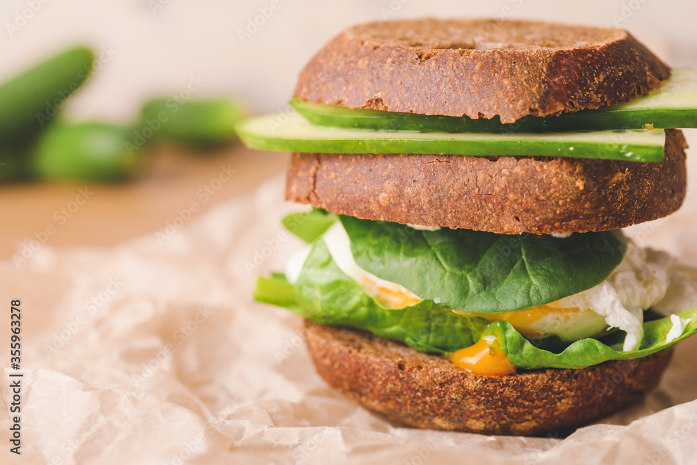 Tasty cucumber sandwich on table