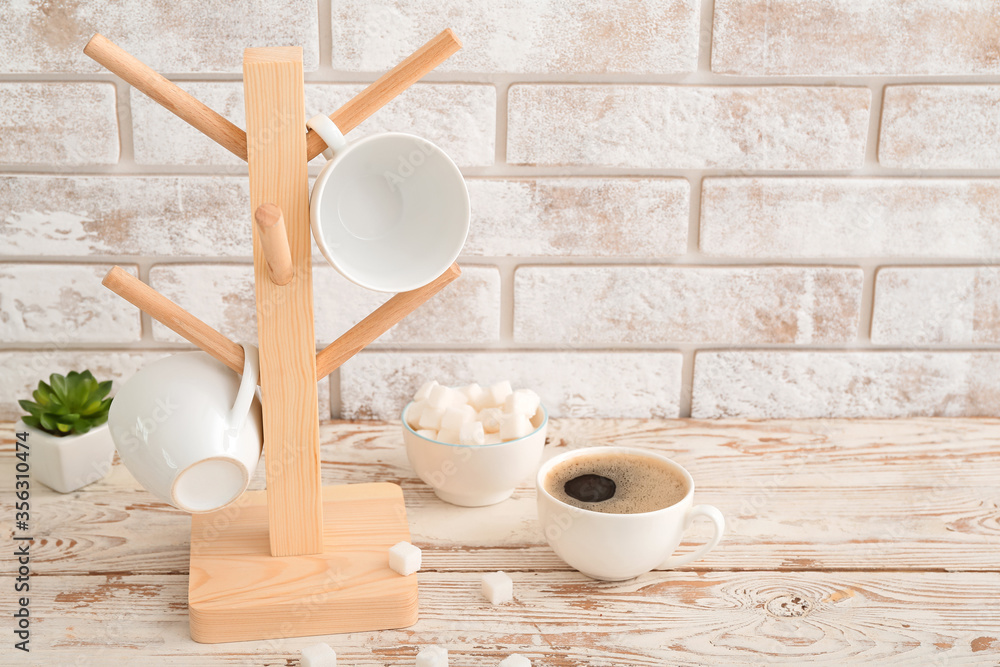 Holder with cups on kitchen table