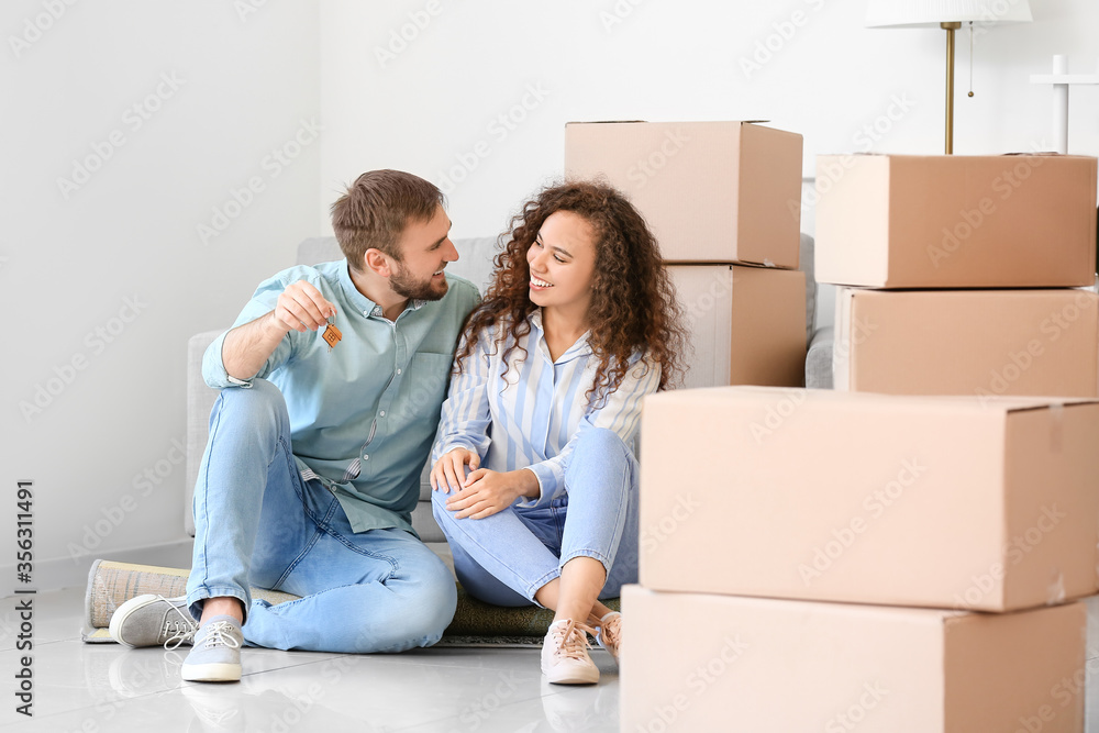 Happy young couple in their new flat on moving day