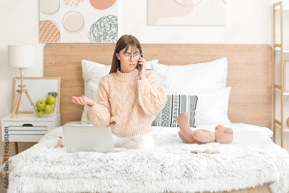 Working woman in bedroom at home