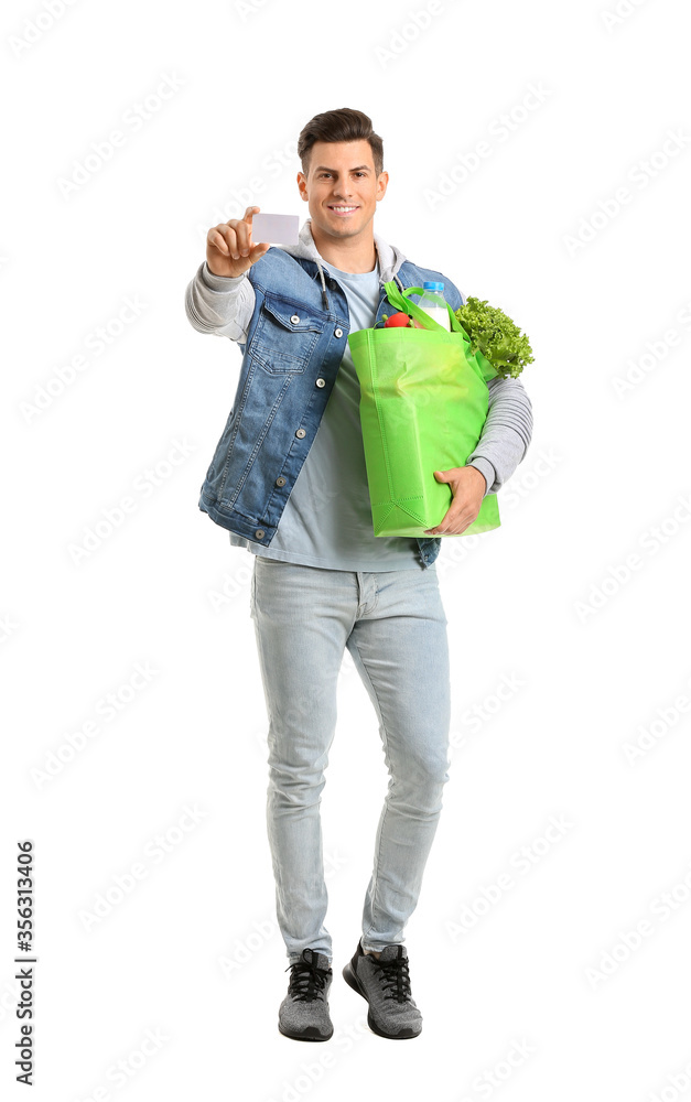 Young man with food in bag and business card on white background