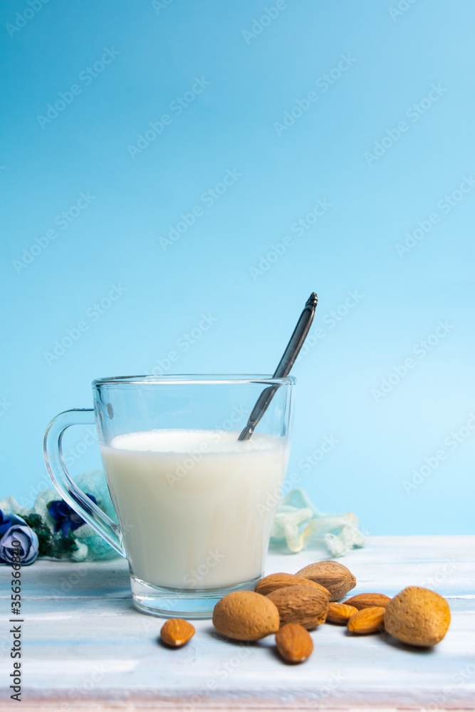 Almond Milk in a Glass on blue background