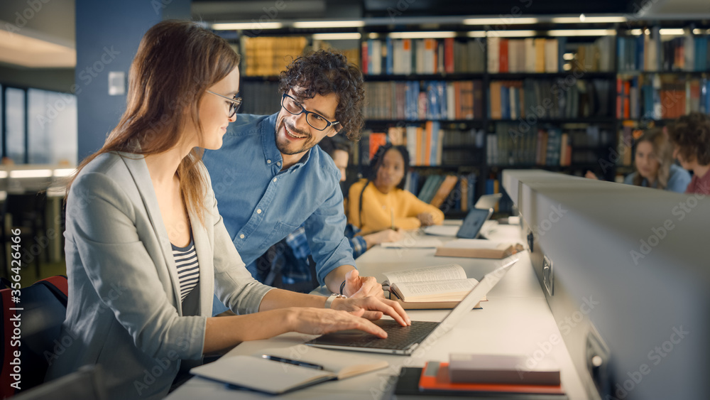 University Library: Talented Caucasian Girl uses Laptop, Smart Helpful Classmate Explains and Advice