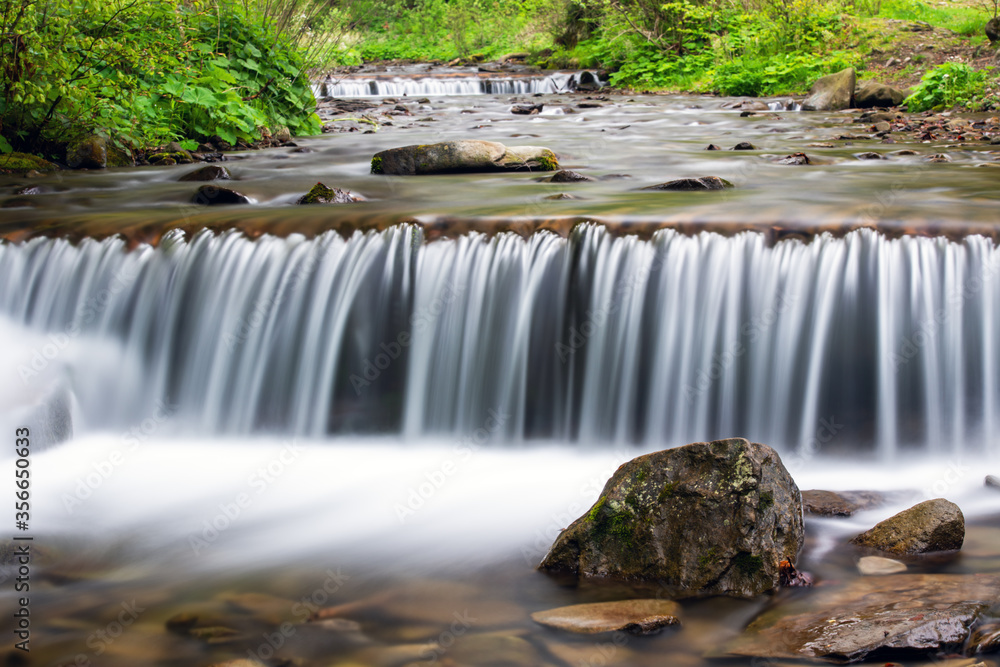 Small stream waterfall on spring forest. Nature background. Landscape photography