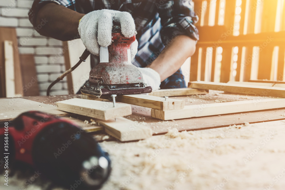 Carpenter working on wood craft at workshop to produce construction material or wooden furniture. Th