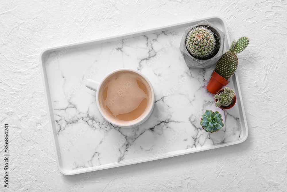 Tray with cup of coffee and houseplants on white background