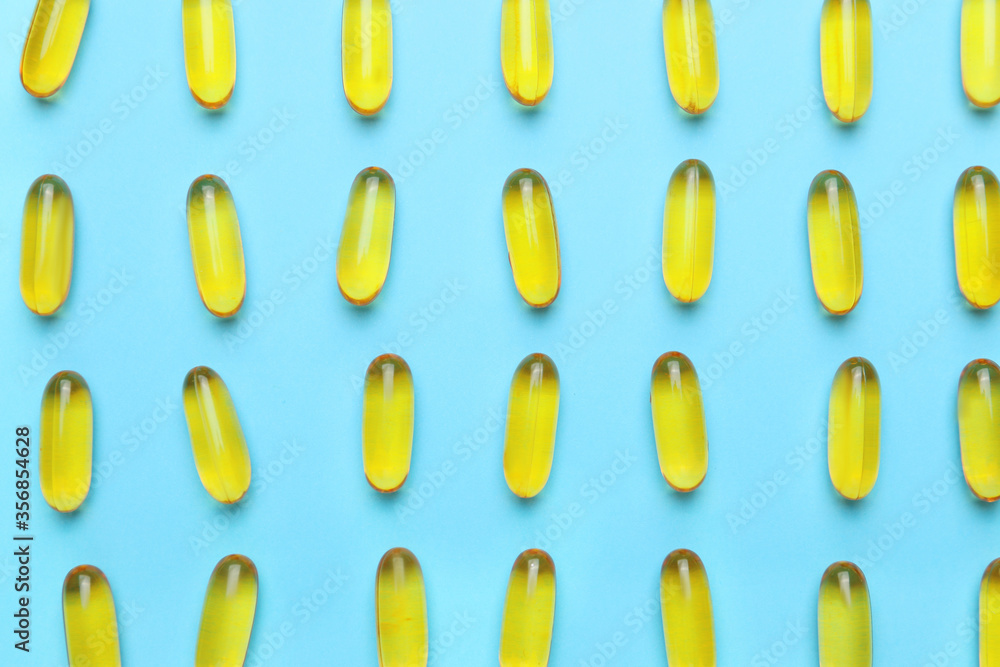 Fish oil capsules on color background