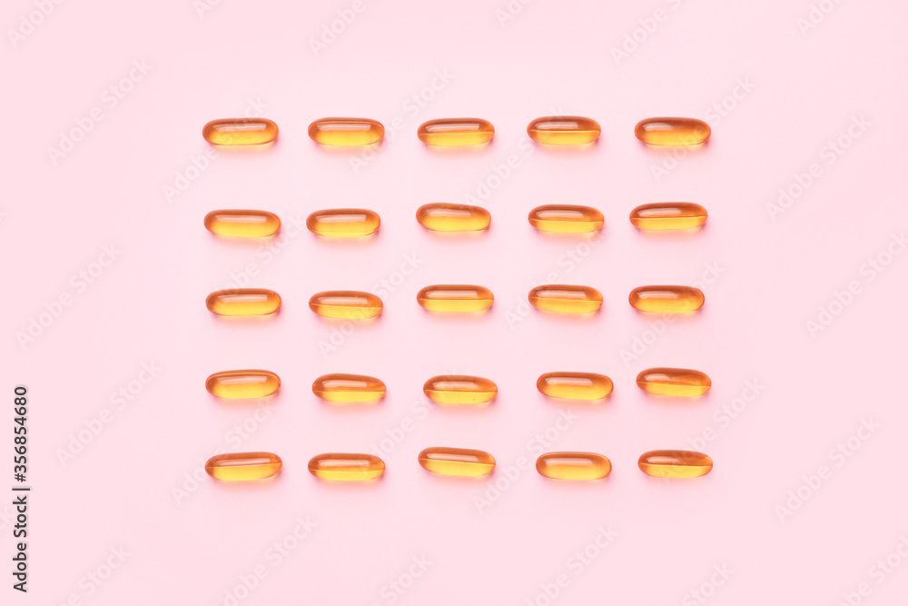 Fish oil capsules on color background