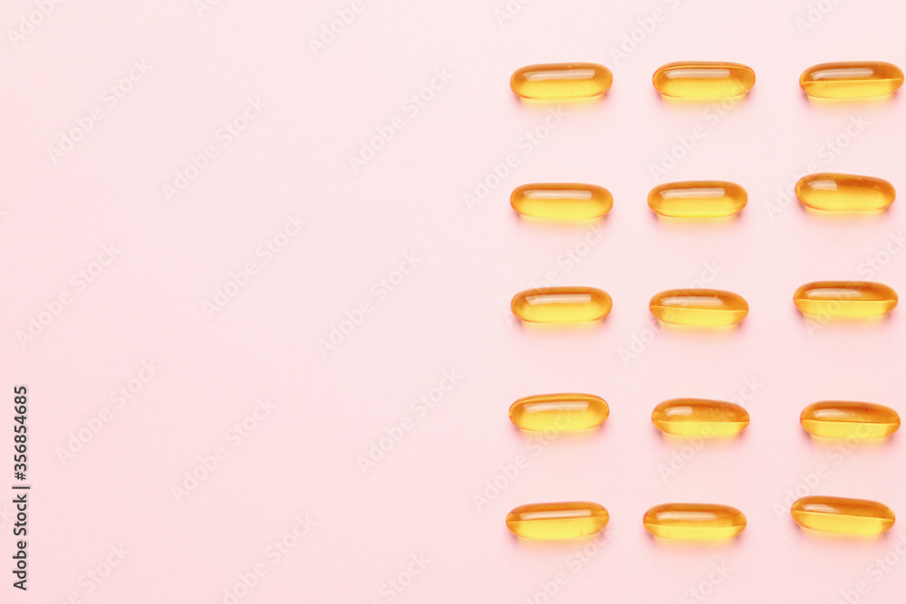 Fish oil capsules on color background