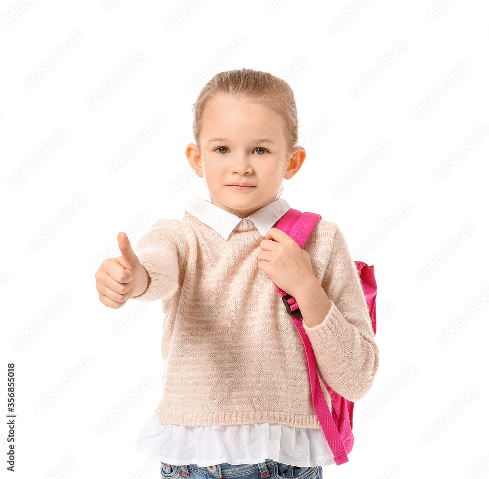 Cute little schoolgirl showing thumb-up on white background