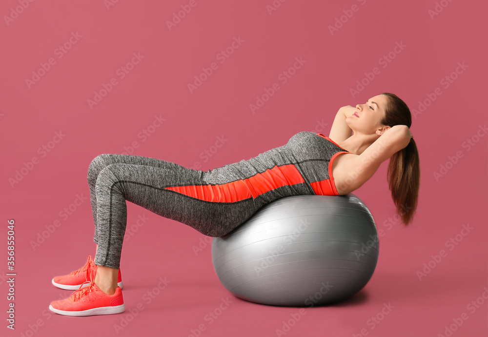 Sporty young woman training on color background