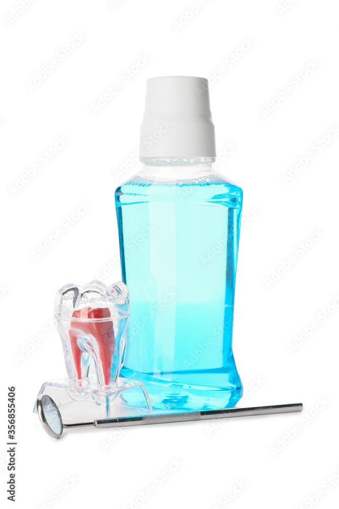 Mouthwash with dental mirror on white background