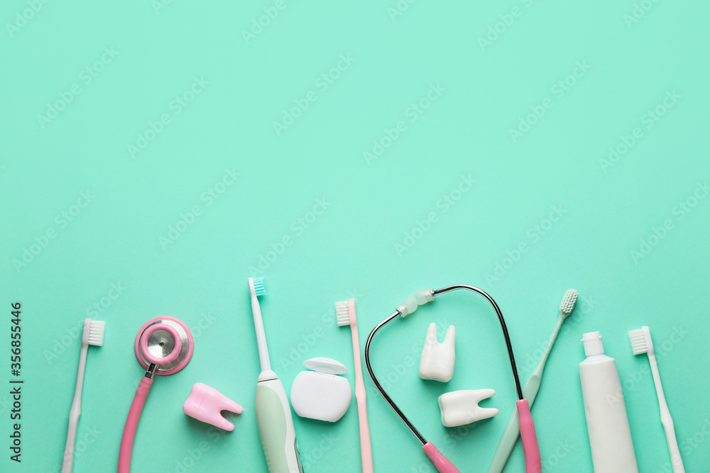 Set for oral hygiene with stethoscope on color background