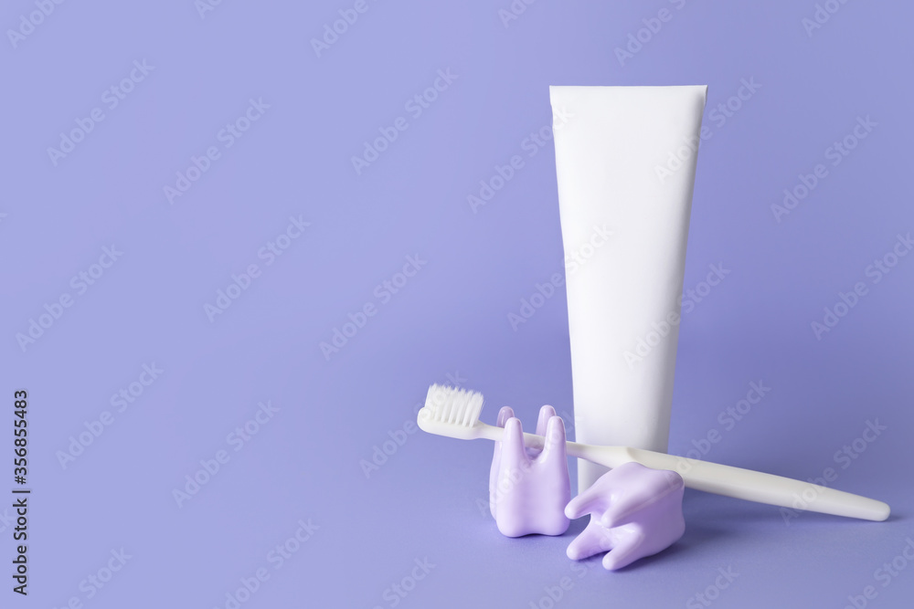 Teeth with toothbrush and paste on color background