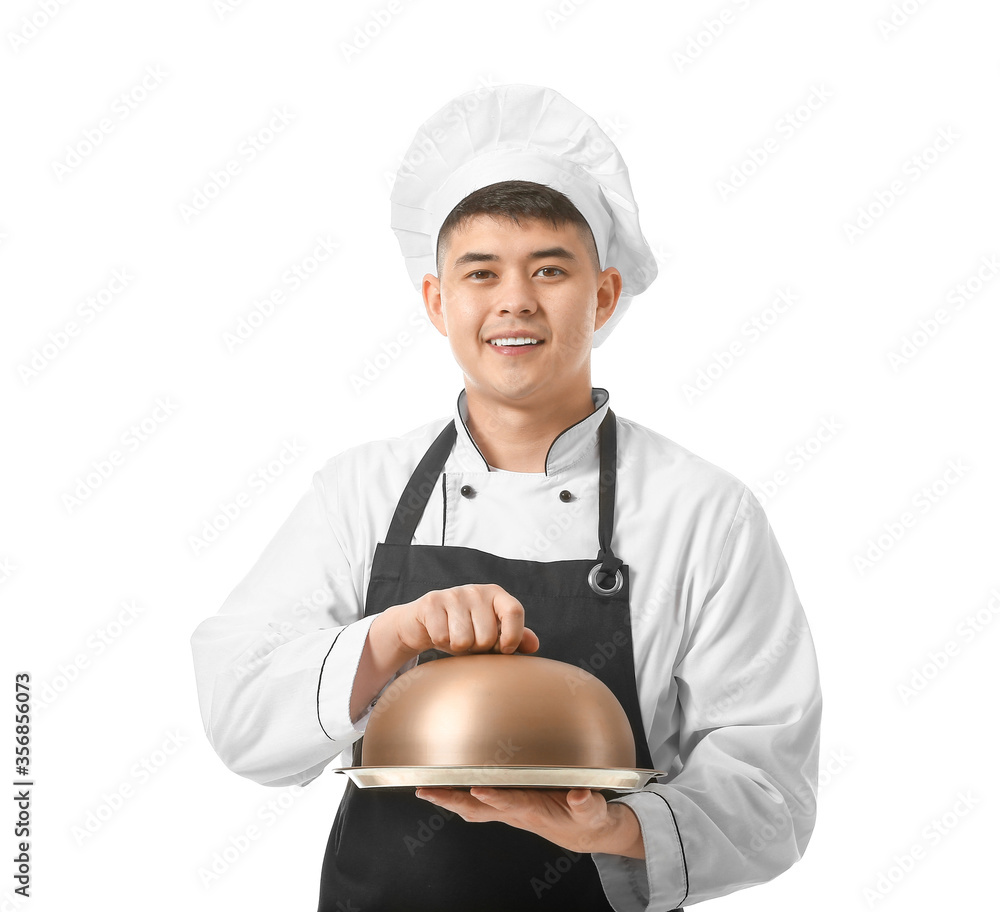 Handsome Asian chef with tray on white background