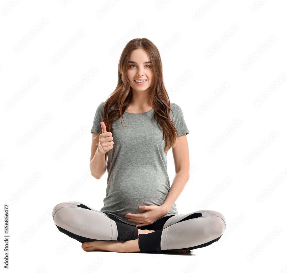 Sporty pregnant woman on white background